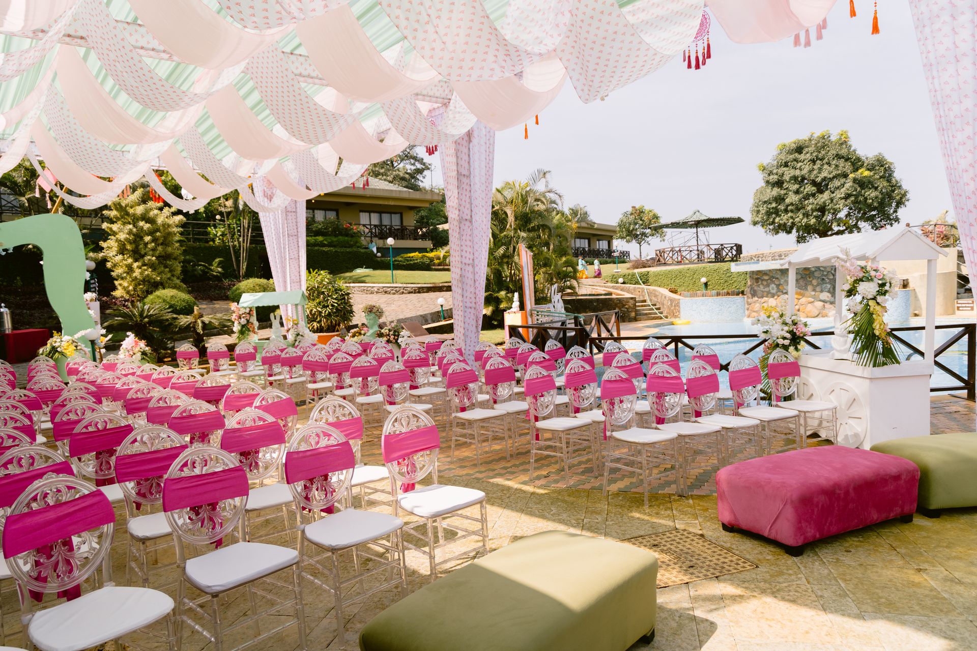 Vibrant Haldi setup with tropical floral decor and brass urli